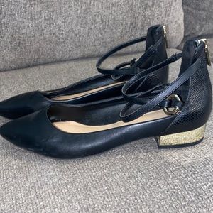 Black leather flats with small gold heel. Very cute